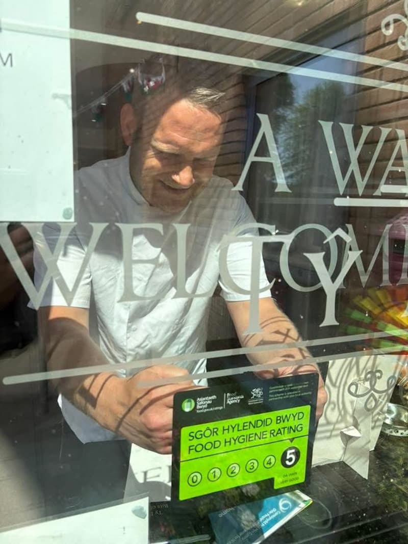 our chef putting our 5* environmental rating on the window