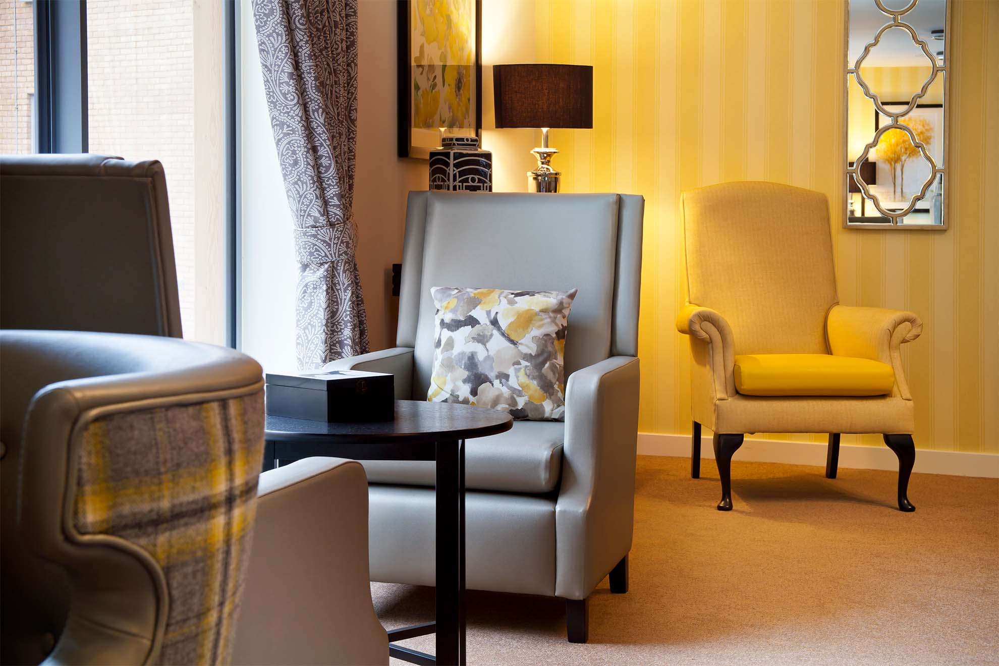 A grey chair and coffee table 