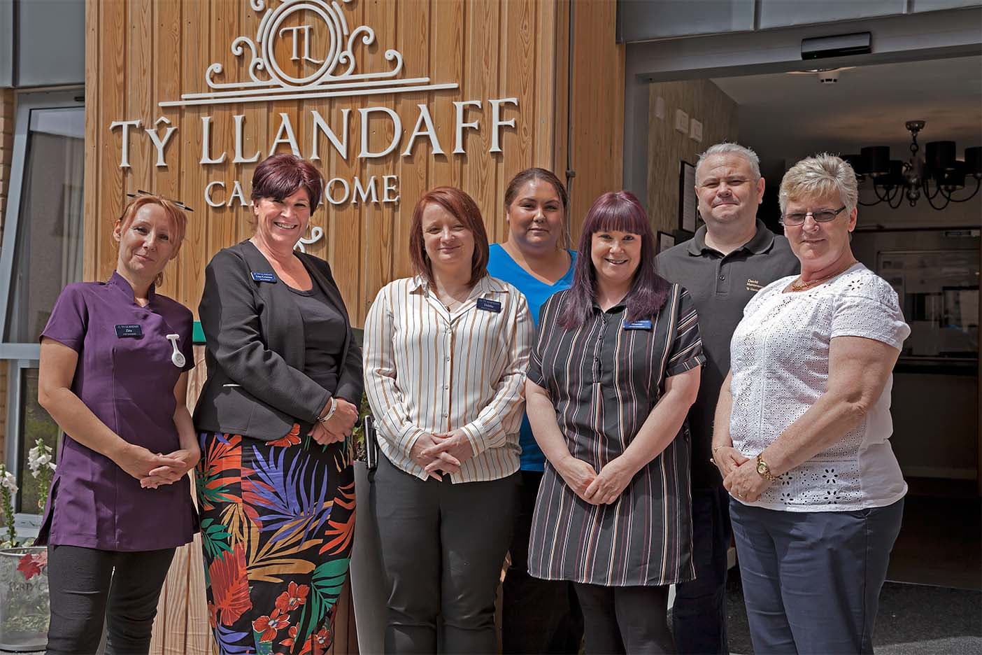 Staff outside the home entrance