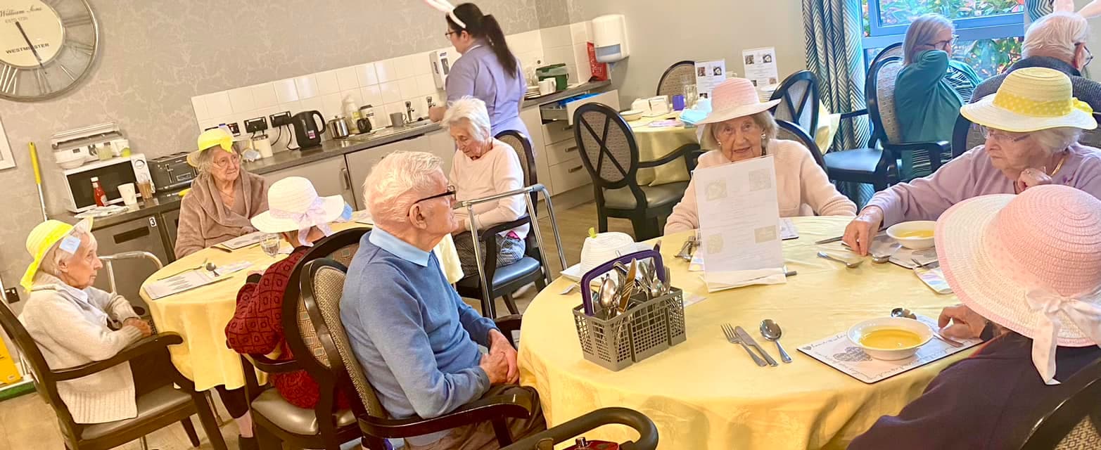 Our residents sat around a table at our Easter lunch at Ty Llandaff Care Home