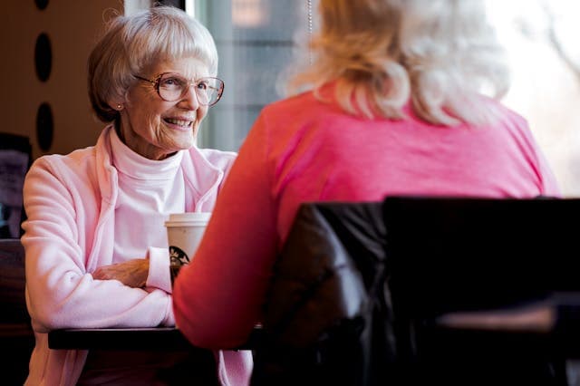 two residents sat at a table chatting