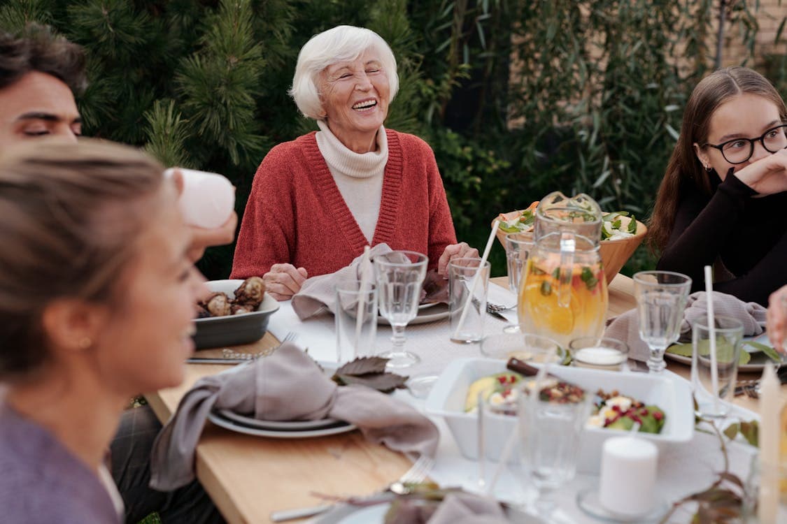 resident sat at table laughing with loved ones