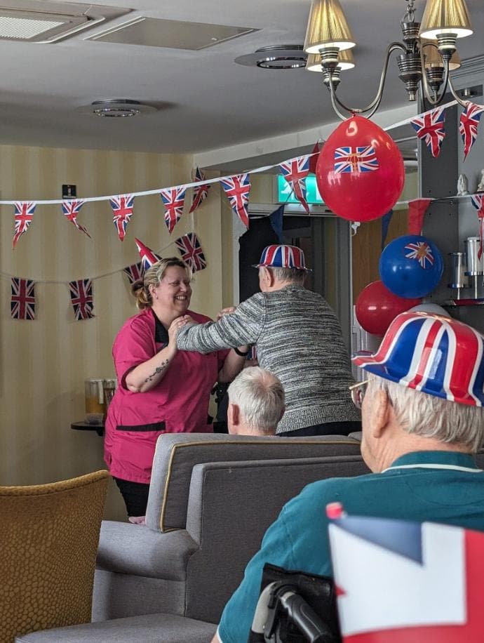 resident and staff dancing