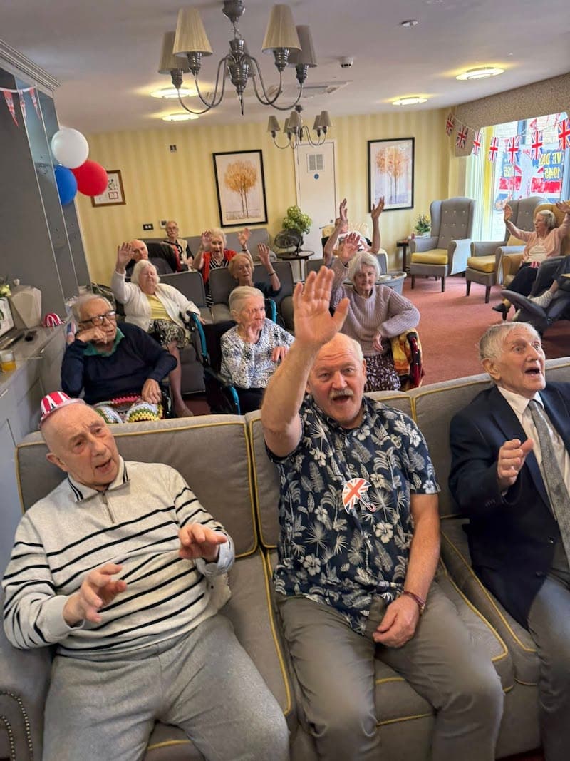 Residents singing along to our VE day entertainer
