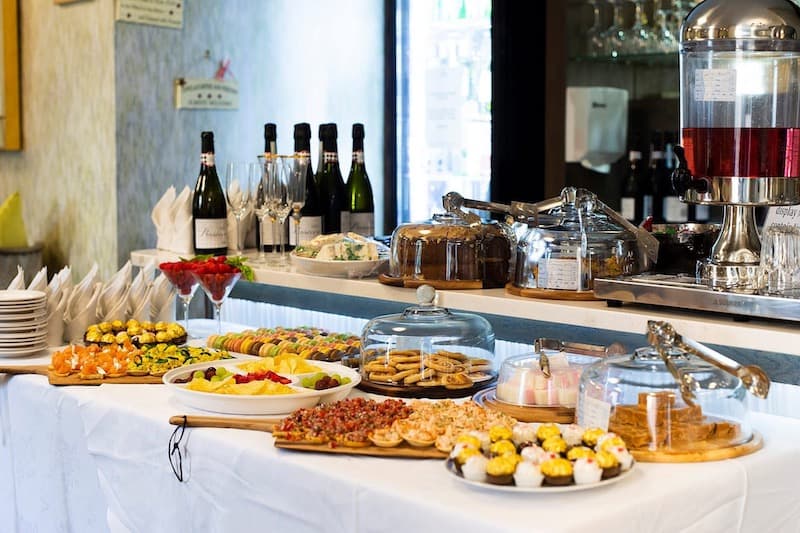 snacks on a table with cakes and fruit