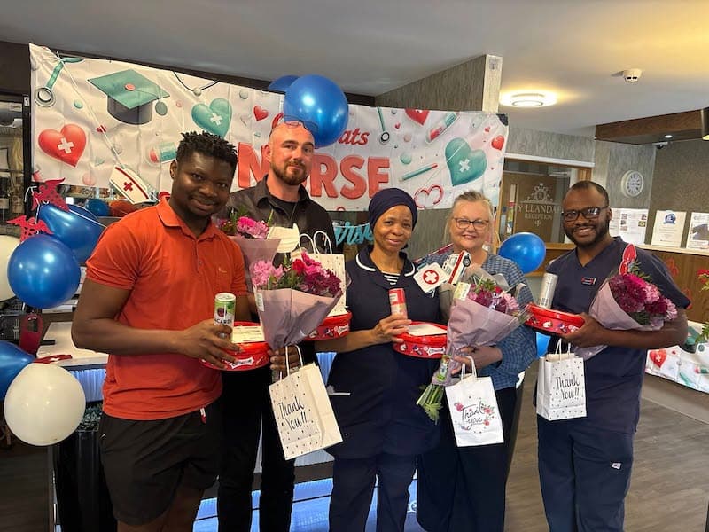 team members with presents on international nurses