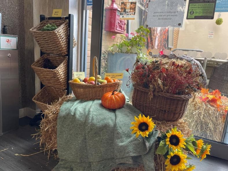an autumn display with pumpkins and sunflowers