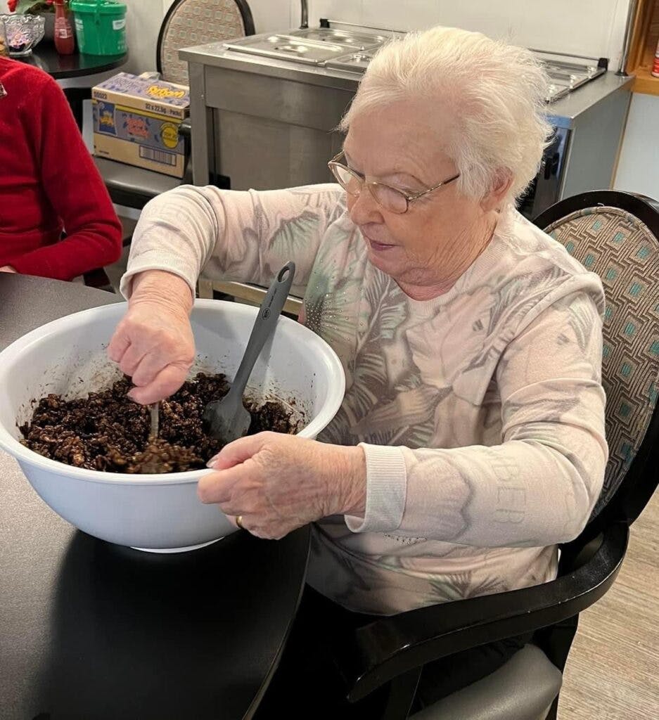 A resident making christmas treats at Ty Llandaff Care Home
