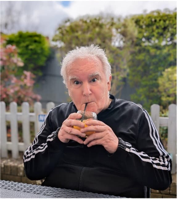 resident enjoying a drink in the beer garden