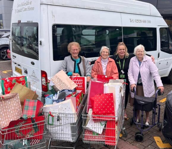 residents stood with gifts next to our minibus