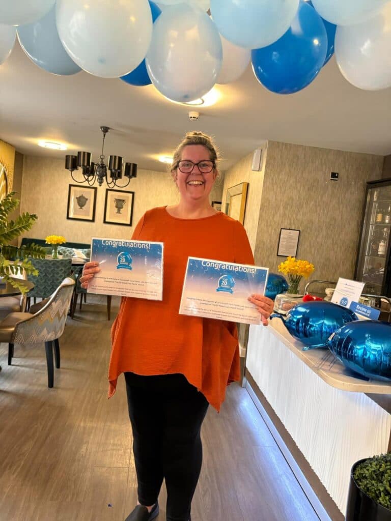 kath our home manager with certificates