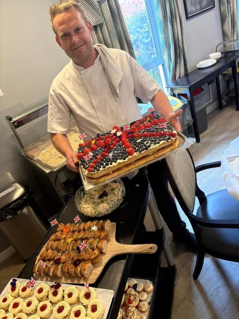 chef stood with VE day snacks for afternoon tea