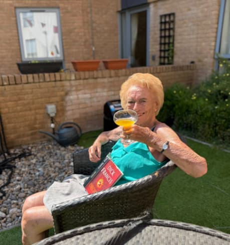 Resident enjoying a dink in the garden