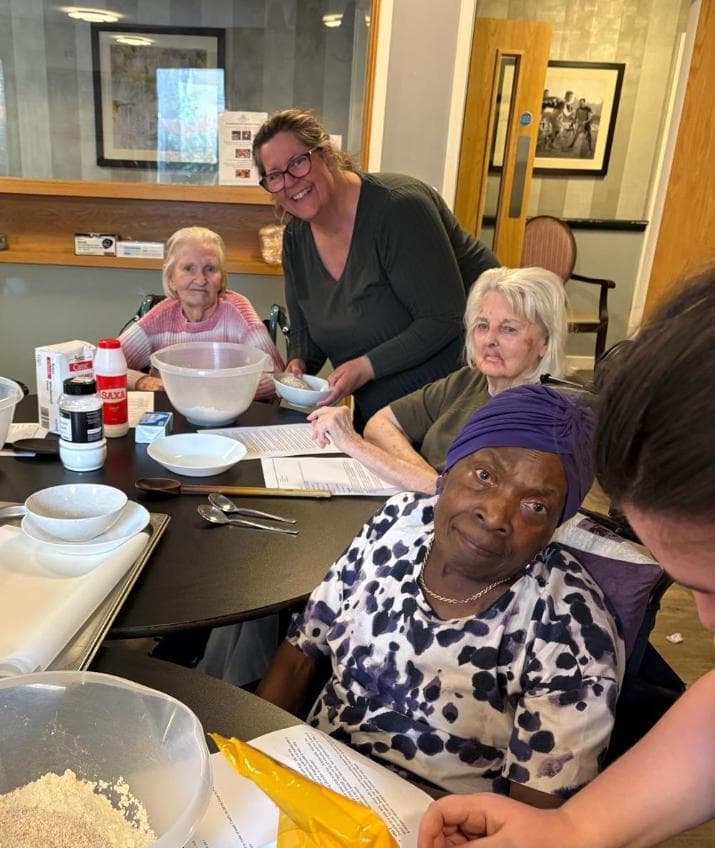 residents sat around a table with mixing bowls