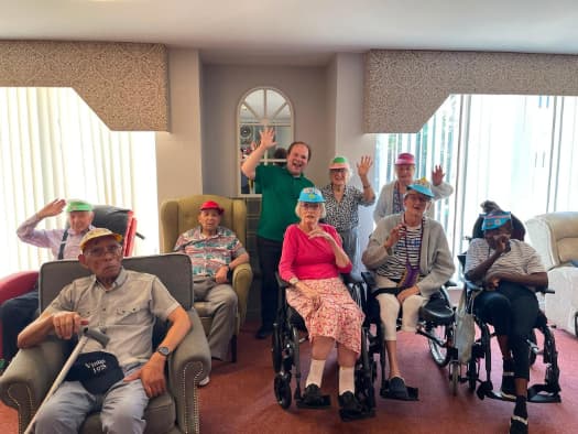 Resident wearing a homemade tennis visor during Art Club at Tŷ Llandaff care home