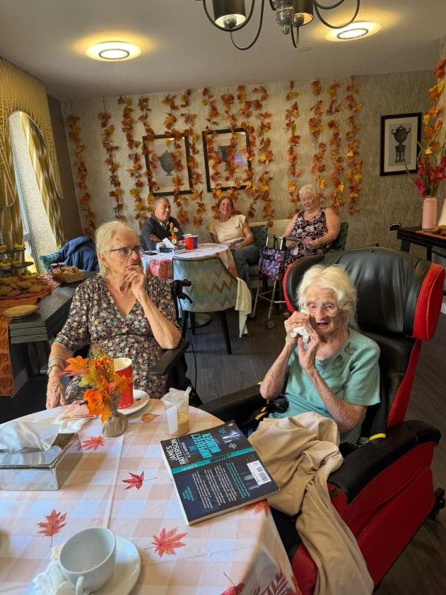 older ladies sat at a table in a dining room